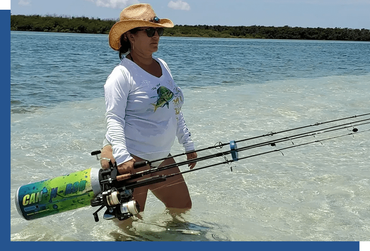 A woman in the water holding two fishing rods.