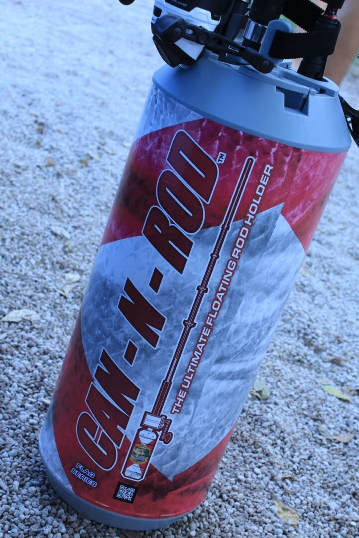 A can of soda is shown on the ground.