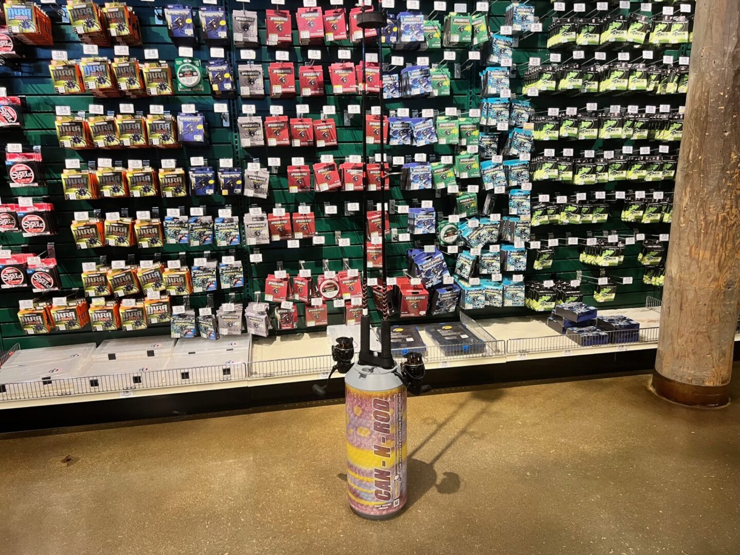 A soda can sitting in front of a wall full of drinks.